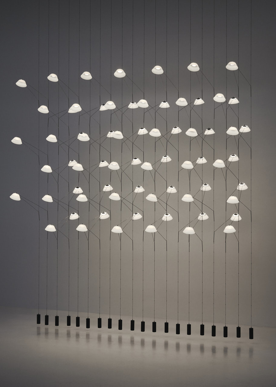 The floating lights are modular lighting system, hand made in Europe. The LED lights are woven into a stainless-steel structure to create a light sculpture that can be arranged in multiple ways, such as a chandelier or light curtain.