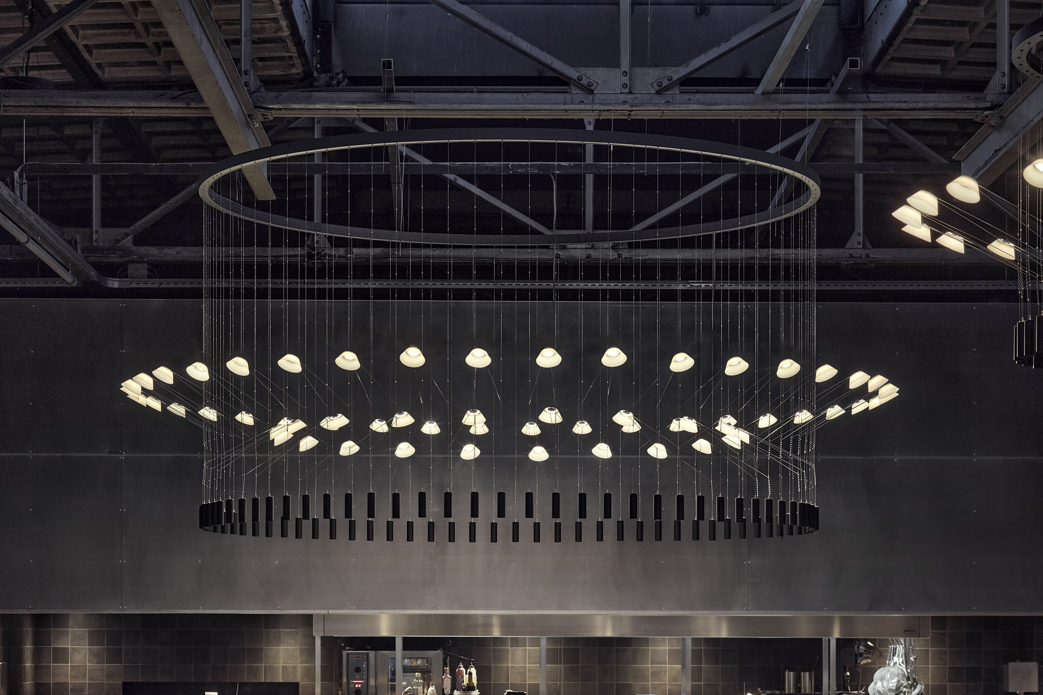 Ceiling lamp at Kazerne, Eindhoven. Lightweight structure, which exists out of various LED lights. Designed by VANTOT.